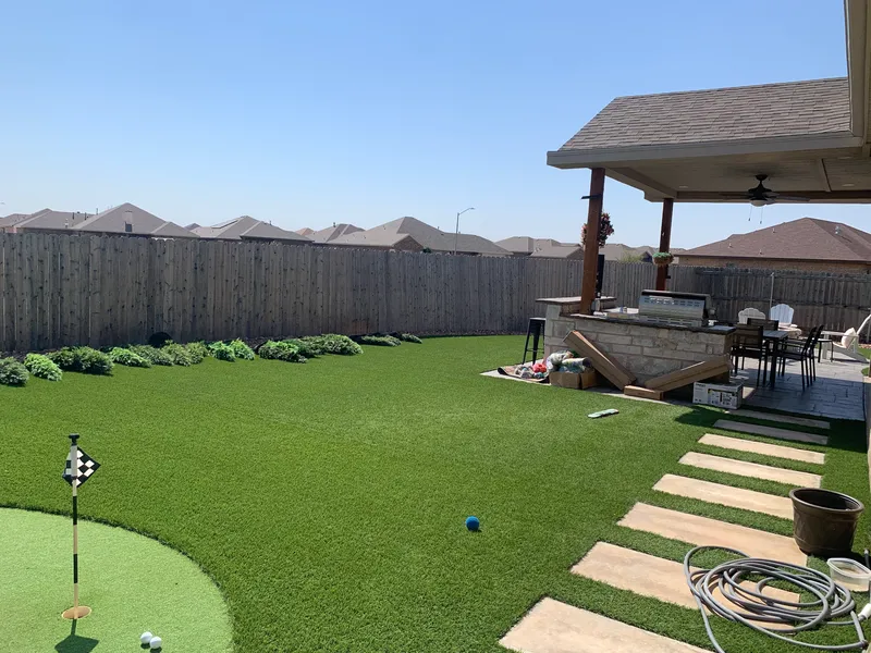 Turf and outdoor living space by E and J General Construction